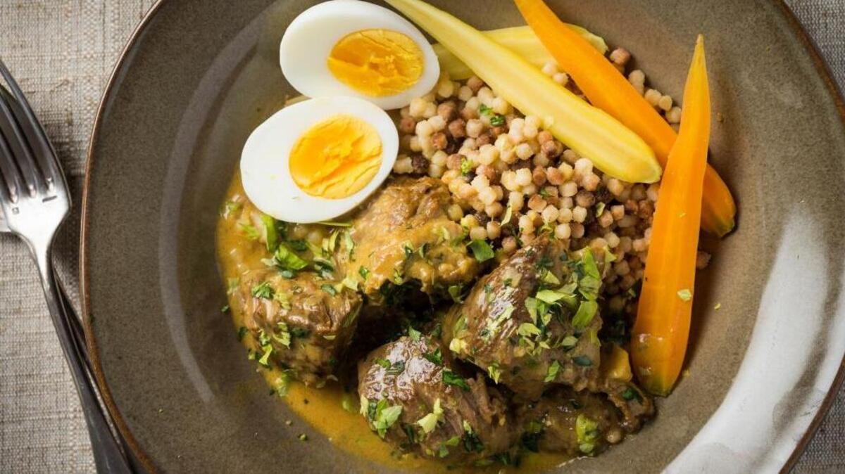 A braised lamb with egg and lemon recipe uses gentle stewing of boneless lamb shoulder to build flavor.