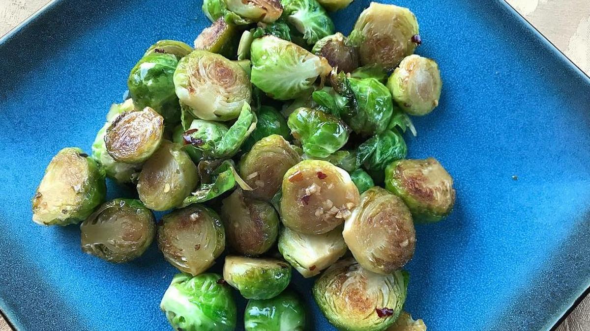 Cast-iron blistered Brussels sprouts are drizzled with a sauce made with honey, garlic, soy sauce and dried crushed red peppers.