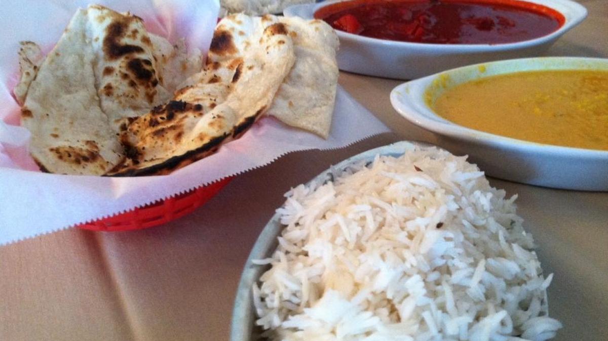 Fiery vindaloo lamb curry, saucy yellow lentils, basmati rice and garlic naan bread at Masala Bistro.