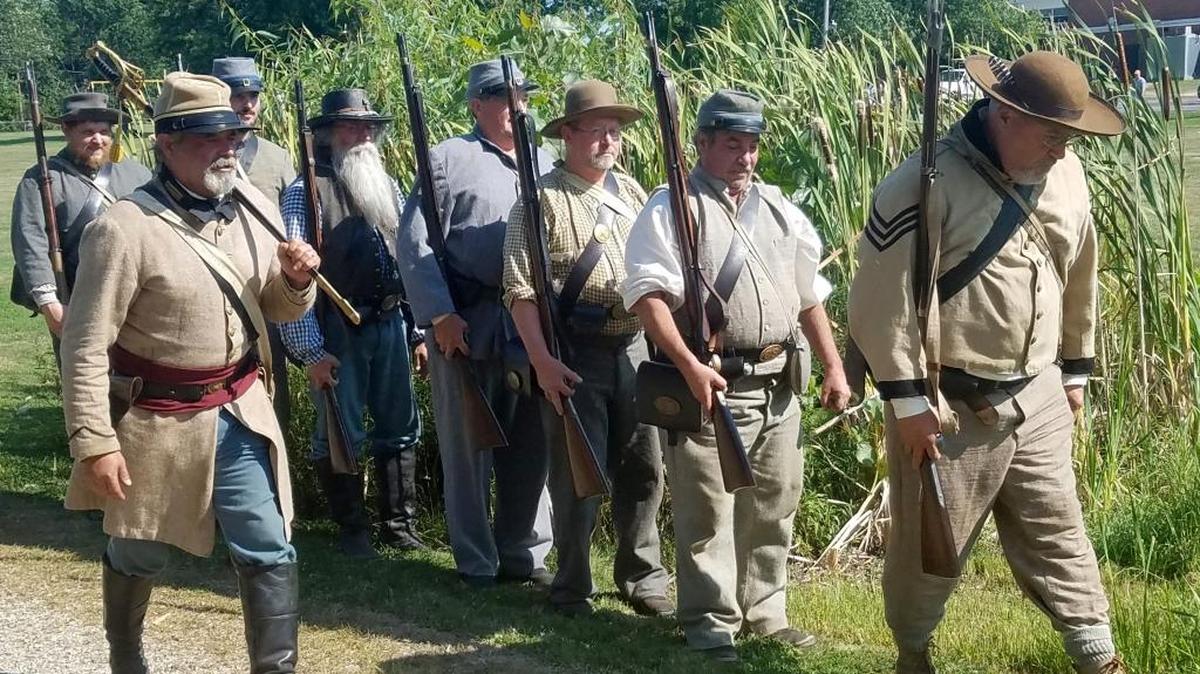 Bob Fragala, 53, of Mooresville, Mich, leads a drill for Confederate solider re-enactors as they march to battle in Three Oaks, Mich.