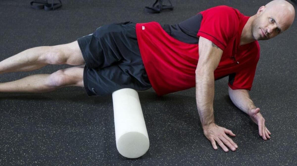 Foam rollers are great recovery tools following workouts. Here, Jason Wanlass uses the roller on his IT band.