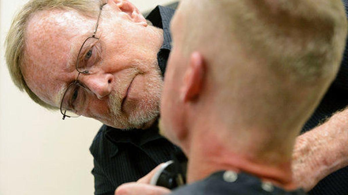 Stuart Stone cuts a man's hair at the Weigland Center in Salt Lake City Monday April 17, 2017. Stone as been volunteering his services giving haircuts to homeless individuals for some 20 years.