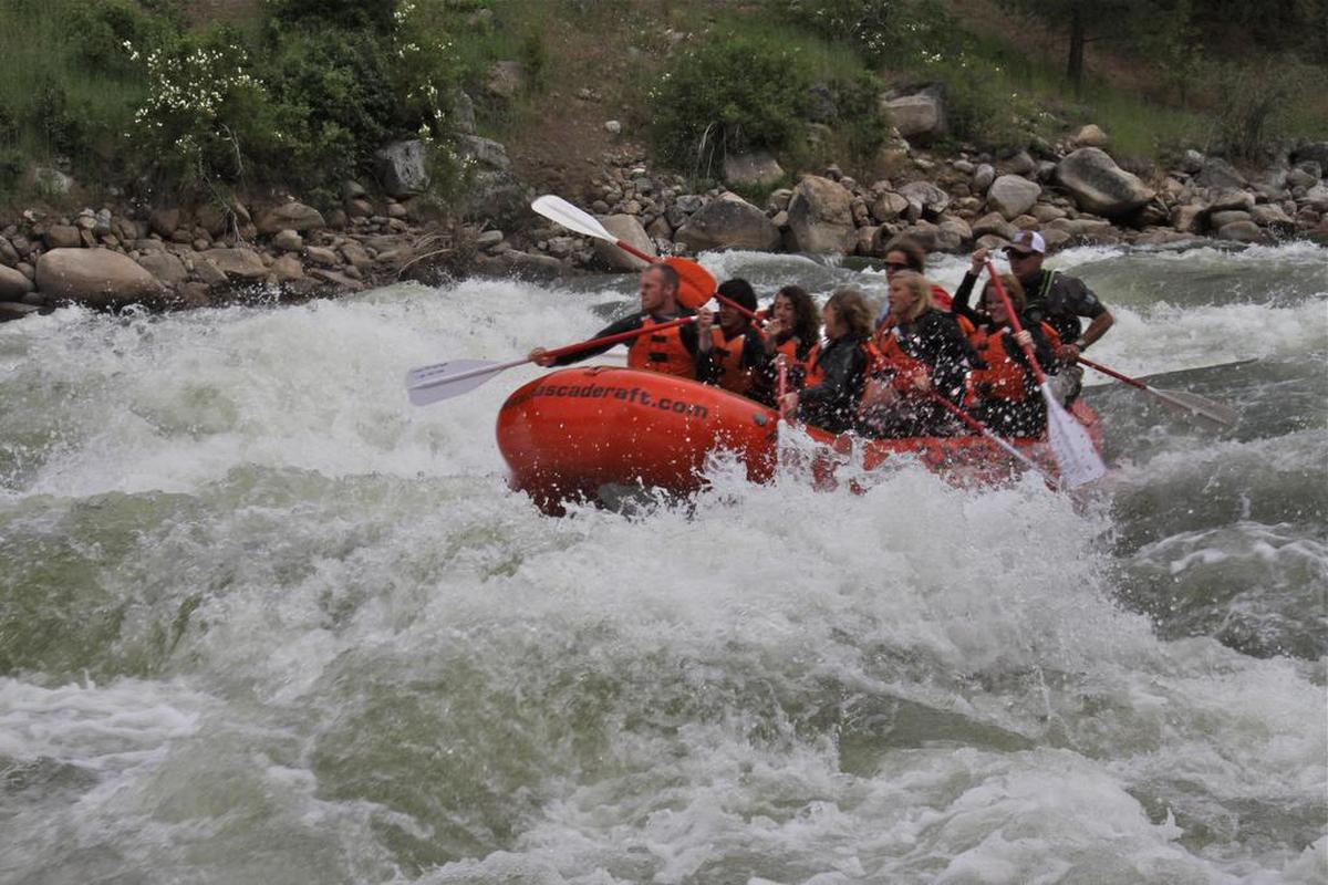 A guide from Cascade Raft and Kayak takes a group through Go Left Rapids on the Main Payette River in late June.