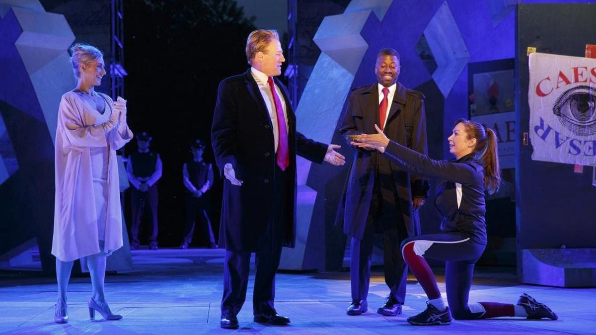 Tina Benko, left, portrays Melania Trump in the role of Caesar’s wife, Calpurnia, and Gregg Henry, center left, portrays President Donald Trump in the role of Julius Caesar during a dress rehearsal of The Public Theater’s Free Shakespeare in the Park production of “Julius Caesar” in New York.