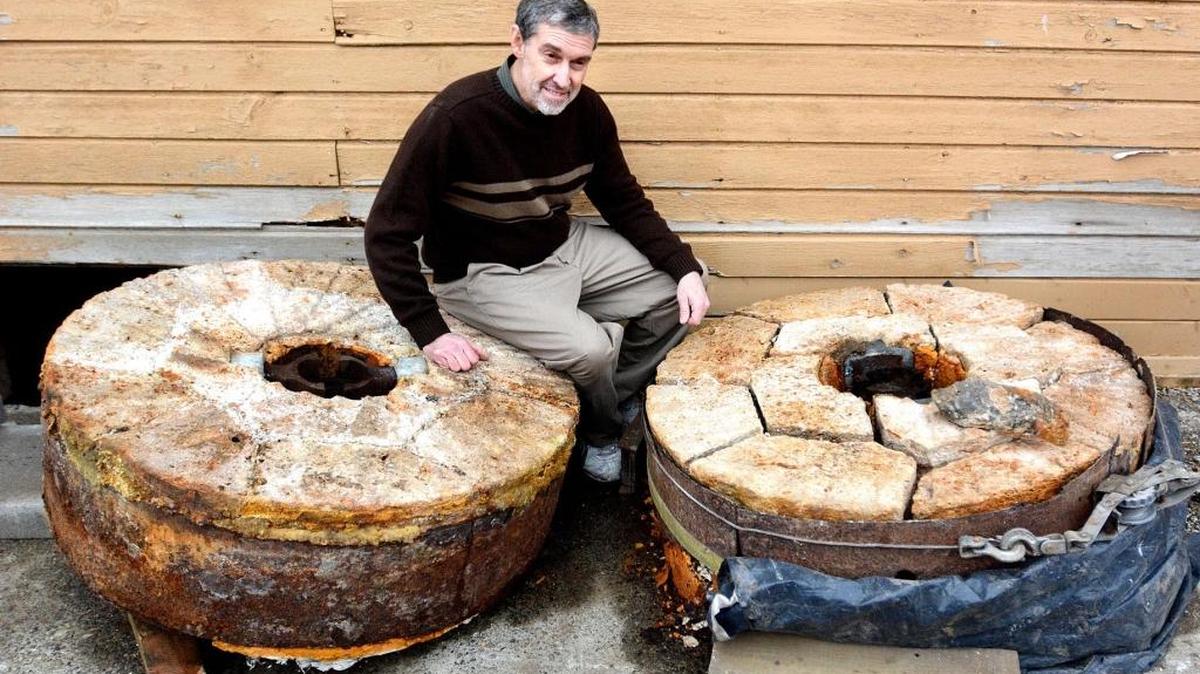 Pastor John Van Vogt shows two millstones unearthed from under the Pataha Flour Mill recently in southeastern Washington, wheels in use until 1889.