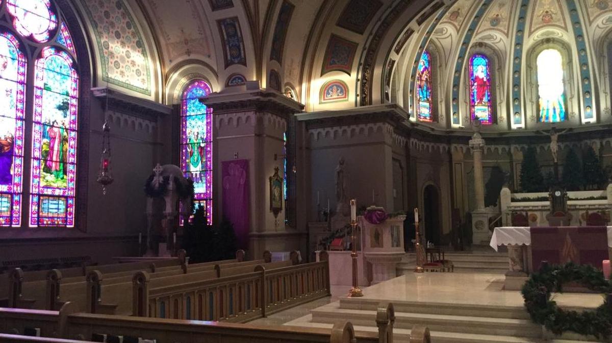 Interior, St. John’s Cathedral. All of the stained glass windows date from the 1920s, except for the window directly behind the high altar that was added later during a restoration in the late 1970s. Its style is distinctly different.
