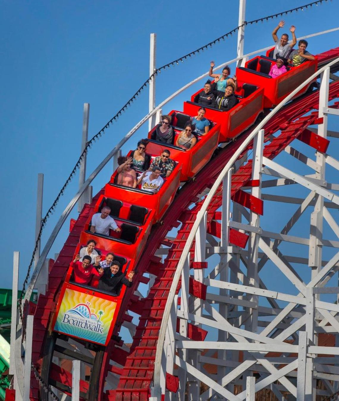 Visitors ride the Giant Dipper Roller Coaster at the Santa Cruz Beach Boardwalk in Santa Cruz, Calif.
