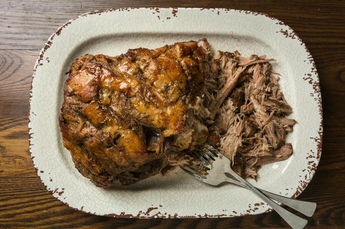 This garlicky citrus marinade turns a plain pork shoulder into a Puerto Rican classic. Pernil Asado means “roasted ham,” the original ingredient. Now, it is more often made with pork shoulder.