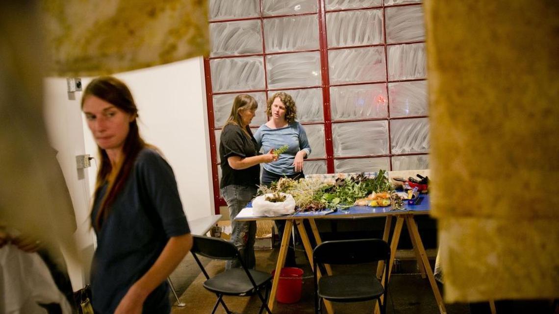 Kathrin Niemann (left) and Kristen Cooper (back, right), artists in residence at Ming Studios in Downtown Boise, help students during a natural fabric-dying class. Ming Studios is an international artist residency, gallery and event venue. Founded just over a year ago, it is emerging as one of Boise’s creative hot spots.