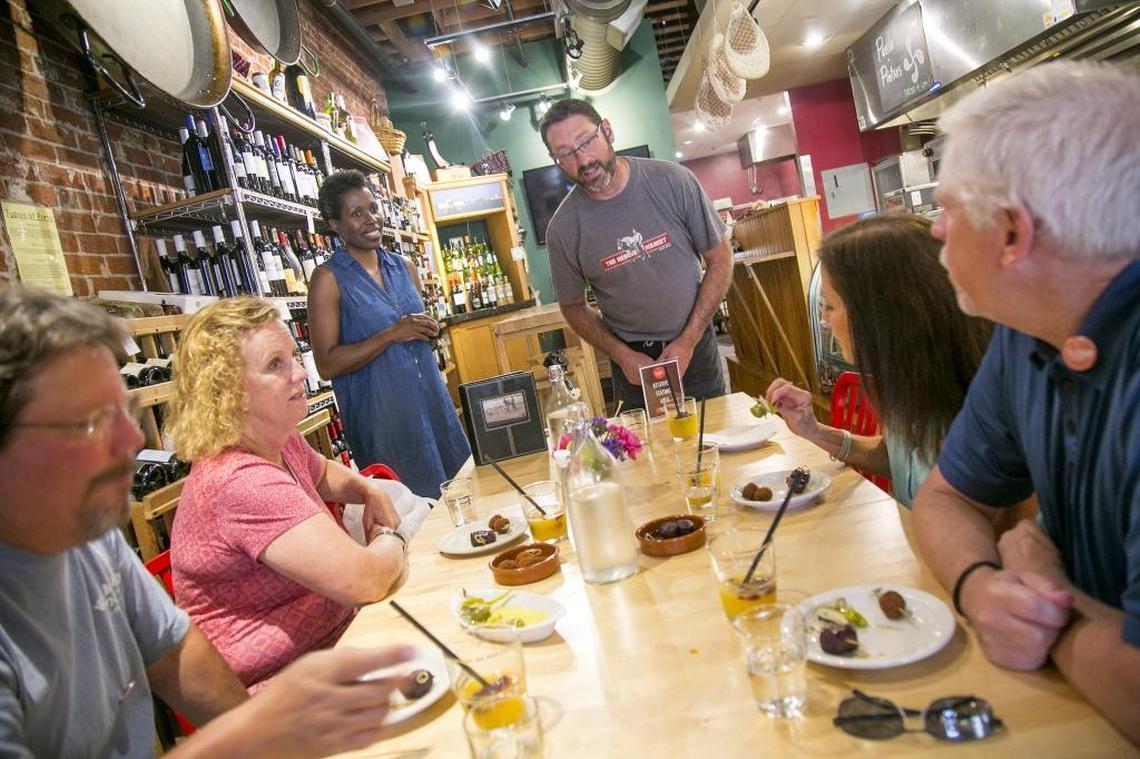 The Basque Market owner Tony Eiguren talks with folks on the Indulge Boise tour, telling family stories and answering questions traditional Basque food.