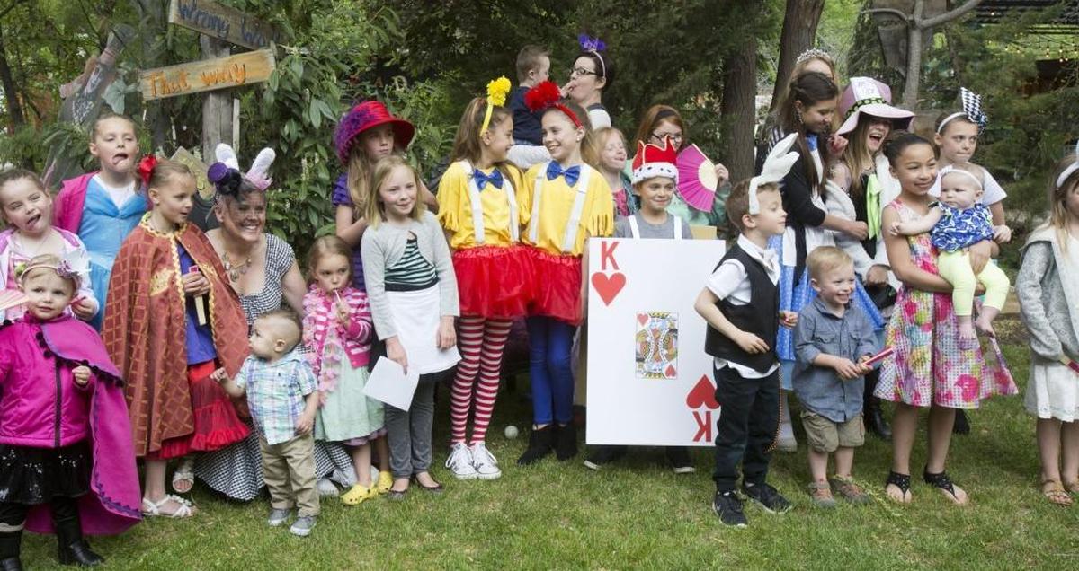 Debbie Lombard-Bloom, left, with rabbit ears, gathers with all the children for the annual photo. The tea party brings 50 to 80 folks together in celebration of the Mad Hatter. Guests dress in Wonderland-themed costumes from the Cheshire Cat to the Red Queen.