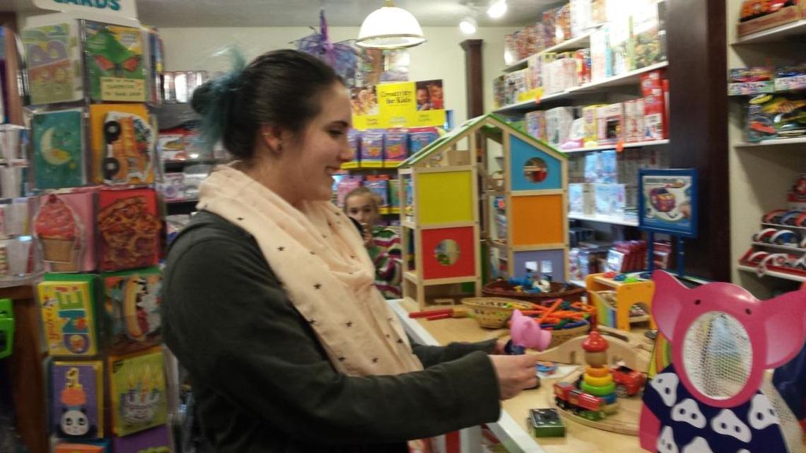 Casey Brown demonstrates a toy inside G. Willikers Toy Merchant.