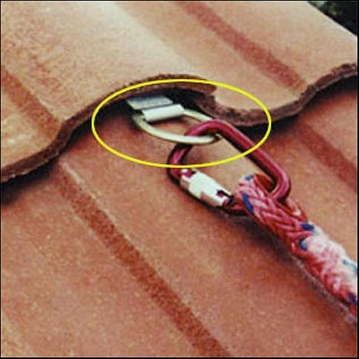 This photo from an Occupational Safety and Health Administration guide shows a roof anchor permanently installed beneath shingles. A local builder includes them — the cost is nominal, maybe $25, he said — on all new roofs.