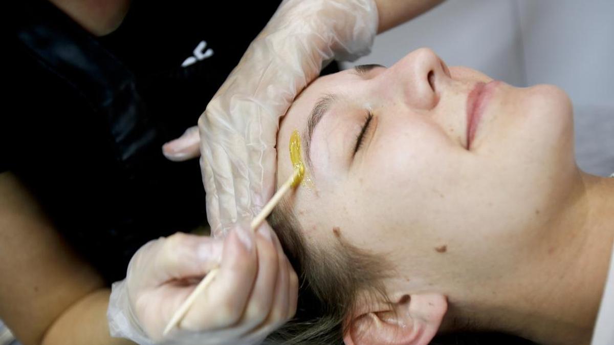 Shelby Johnson, waxologist, performs a eyebrow makeover on Stephanie Turner at LunchBOX (A Waxing Salon) at 818 W. Idaho Street in Downtown Boise.