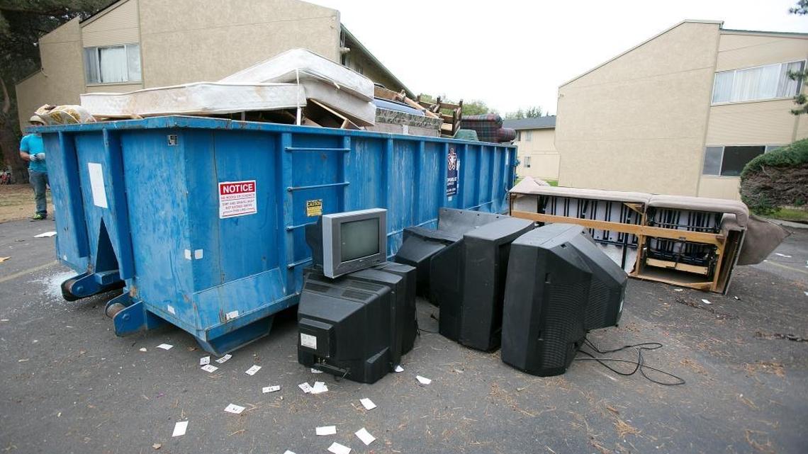 Trash containers are filled with mattresses, couches, and televisions at the Glenbrook Apartments in October 2015 after tenants were ordered to vacate their units.