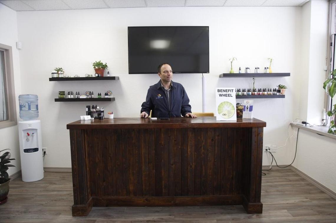 Global CBD owner Joel Bordeaux behind the counter of his store in early March.