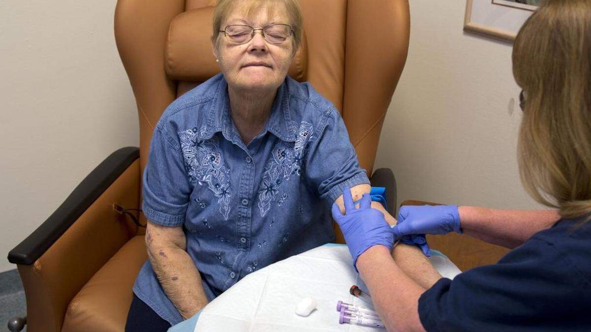 Debbie Birch, a kidney patient, flinches as a nurse draws a blood sample at a DaVita dialysis center in Nampa. Birch uses a home dialysis machine, but she must visit the clinic for blood tests on a regular basis.