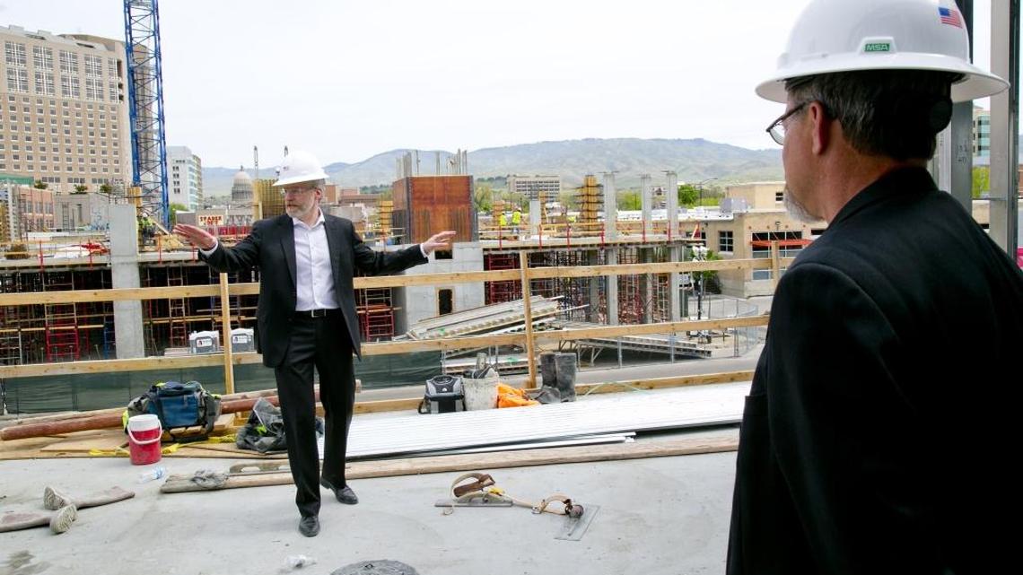 The Inn at 500 Capitol General Manager Aaron Black, left, and architect Craig Slocum, of Boise firm CSHQA, take news media to a second-story overlook at the Downtown Boise construction site.