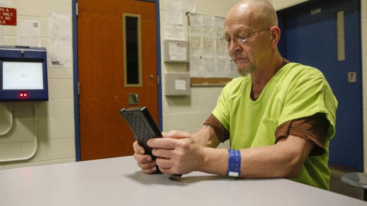 Roger Clark Bretz, an inmate at the Polk County Jail in Des Moines, Iowa, uses a tablet. Jail inmates are exploring the internet, watching movies and contacting loved ones through a pilot project that gives them access to tablet computers.