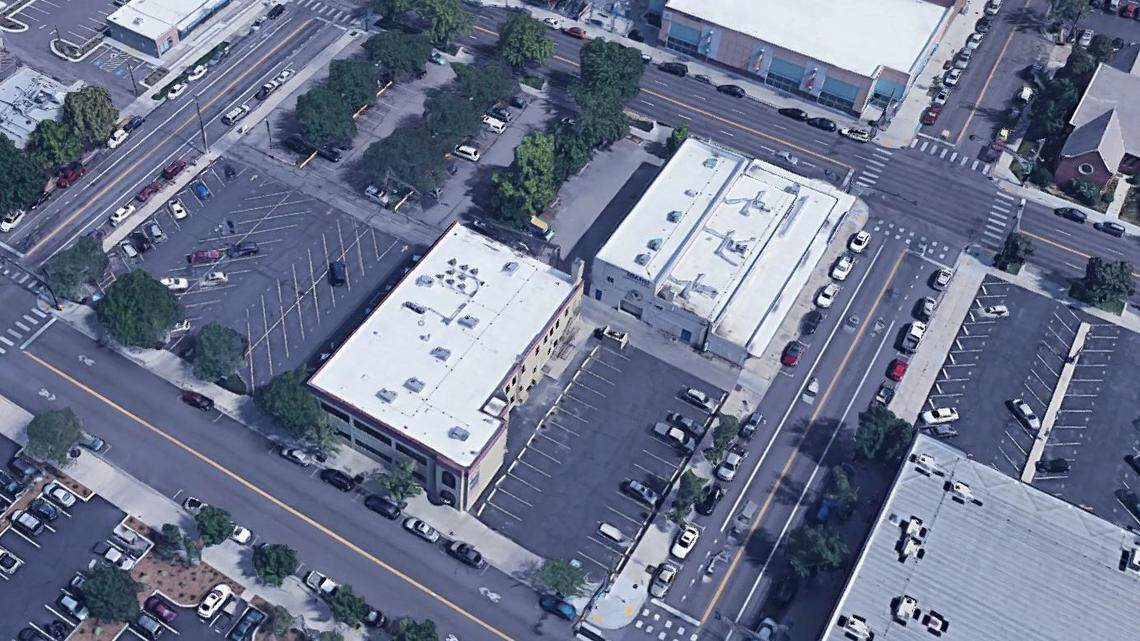 This block is bordered by State Street at the top, Jefferson Street at the bottom, 11th Street at left, and 10th Street at right. The building at upper right, 421 N. 10th St., formerly housed an Idaho Sporting Goods store. It faces the downtown YMCA across State. The lower-left building, 421 N. 10th St., is a two-story office building.