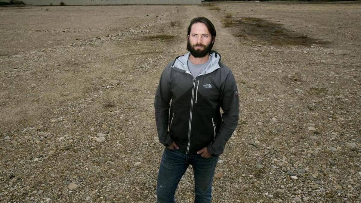 Chance Hobbs, a partner in VCD, hopes to build Moon Valley Apartments in this 2.7-acre empty lot. Many residents of the neighboring Pinewood Lake subdivision behind him oppose the project. “They are saying, ‘Not in our backyard,’ ” Hobbs said. “If I moved the project to a 9-acre lot another 200 yards down the road, they wouldn’t care.”