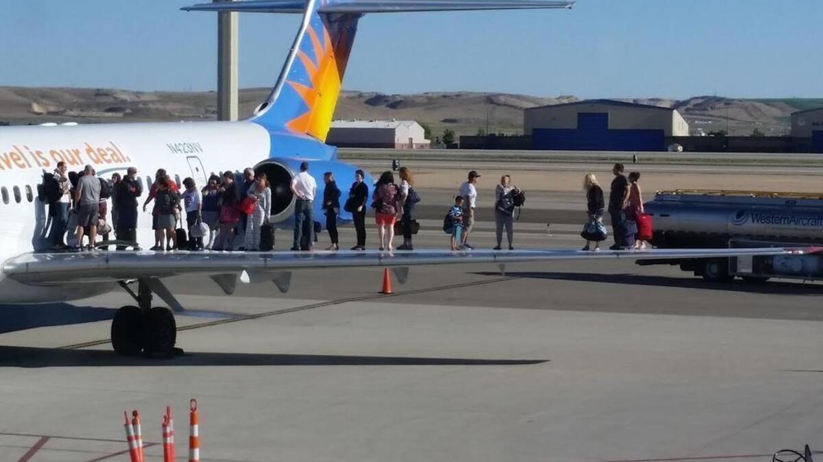 Passengers on Allegiant Air Flight 330 wait on an airplane wing after the plane’s cabin filled with fuel vapors. The airplane malfunctioned as it was landing at the Boise Airport on a Friday in June 2015. No one was injured. “At Allegiant, the safety of our passengers and employees is our No. 1 priority,” the airline said in a statement.