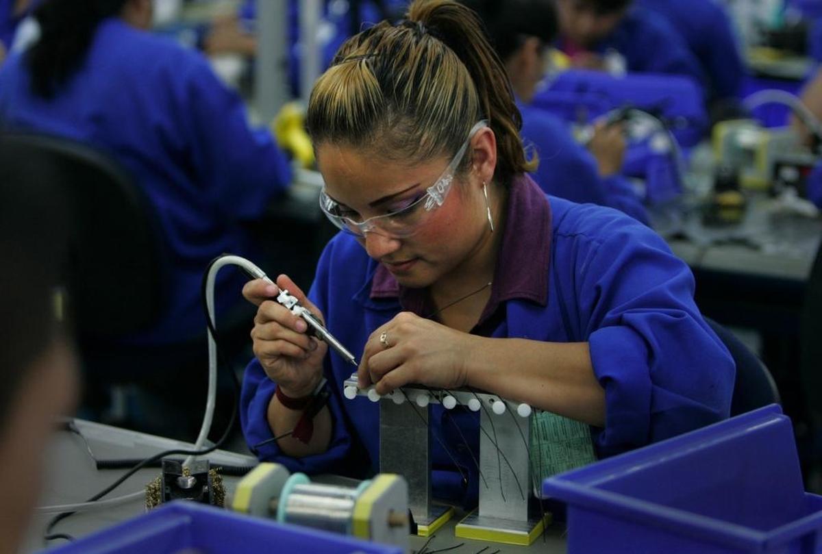 A woman makes communication headsets for the U.S. market at a plant in Tijuana, Mexico, owned by Plantronics, a California company. A tariff on Mexican imports could cause job losses in Mexico and higher prices in the U.S.