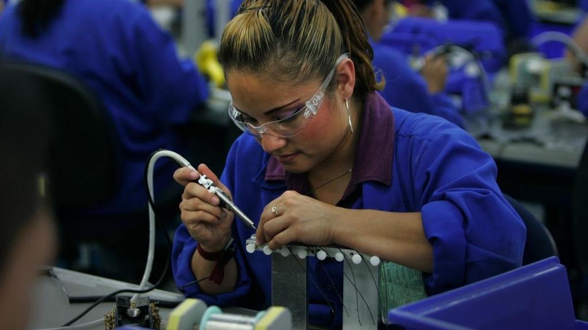 A woman makes communication headsets for the U.S. market at a plant in Tijuana, Mexico, owned by Plantronics, a California company. A tariff on Mexican imports could cause job losses in Mexico and higher prices in the U.S.
