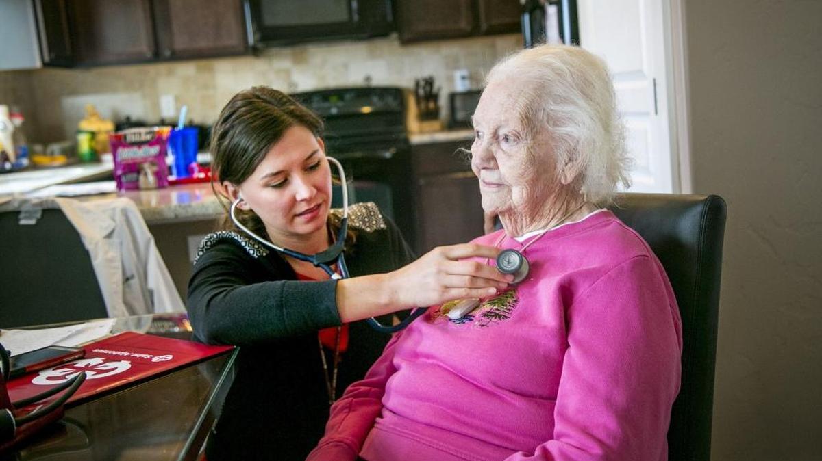 Dr. Kara Kuntz checks the heartbeat of patient Helen Bagwell during a home visit in 2017. Addressing physical, mental and social risk factors can improve cognitive decline, Kuntz told the Idaho Statesman.