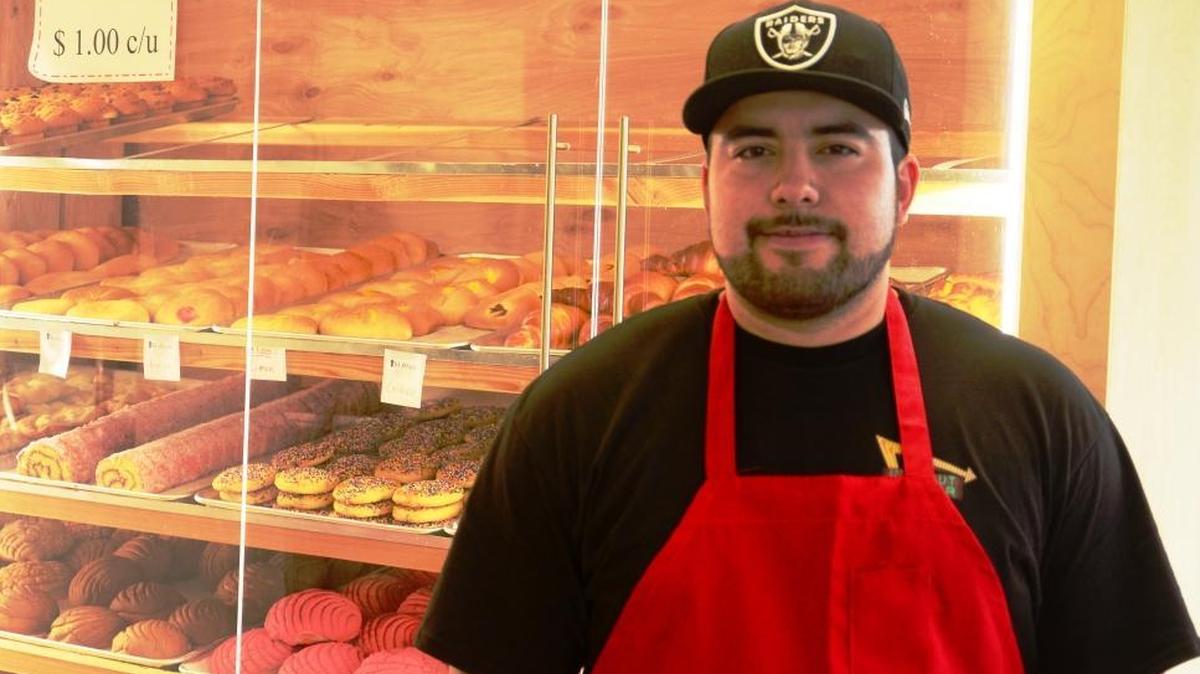 Alberto Contreras Jr., manager of the Panaderia Coalcoman bakery, with one of the shop’s two cases of pastries.