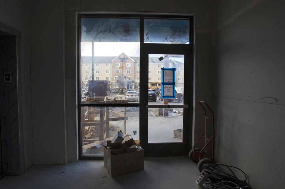 The TownePlace Suites by Marriott is visible through the windows of the Tru by Hilton hotel, just steps to the west.