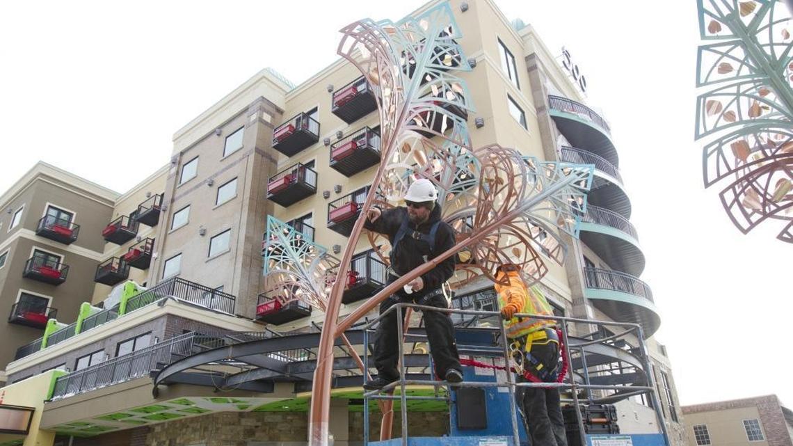 Artist Ken McCall puts finishing touches Friday, Dec. 30, on his sculpture “Symmetry” in front of the soon-to-open Inn at 500 Capitol in Downtown Boise.