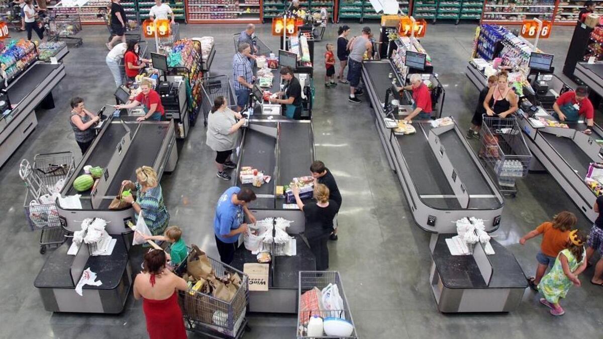 Customers bag their own groceries at checkout counters at WinCo Foods on Fairview Avenue in Boise in this 2013 Idaho Statesman photo. Self-bagging is one way the chain keeps costs low.