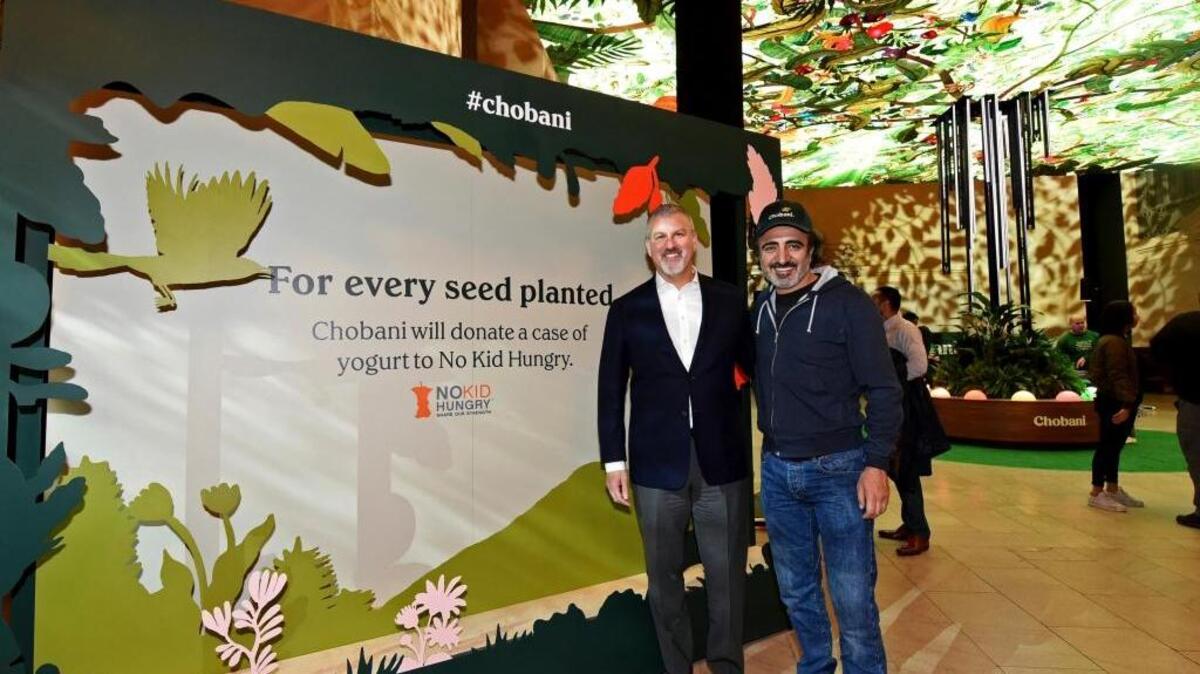Hamdi Ulukaya, right, Chobani founder and CEO, and Peter Kaye, of No Kid Hungry, on Monday announce a donation of a case of yogurt to the No Kid Hungry campaign for every virtual seed “planted” at an interactive Chobani exhibit inside New York's Grand Central Terminal