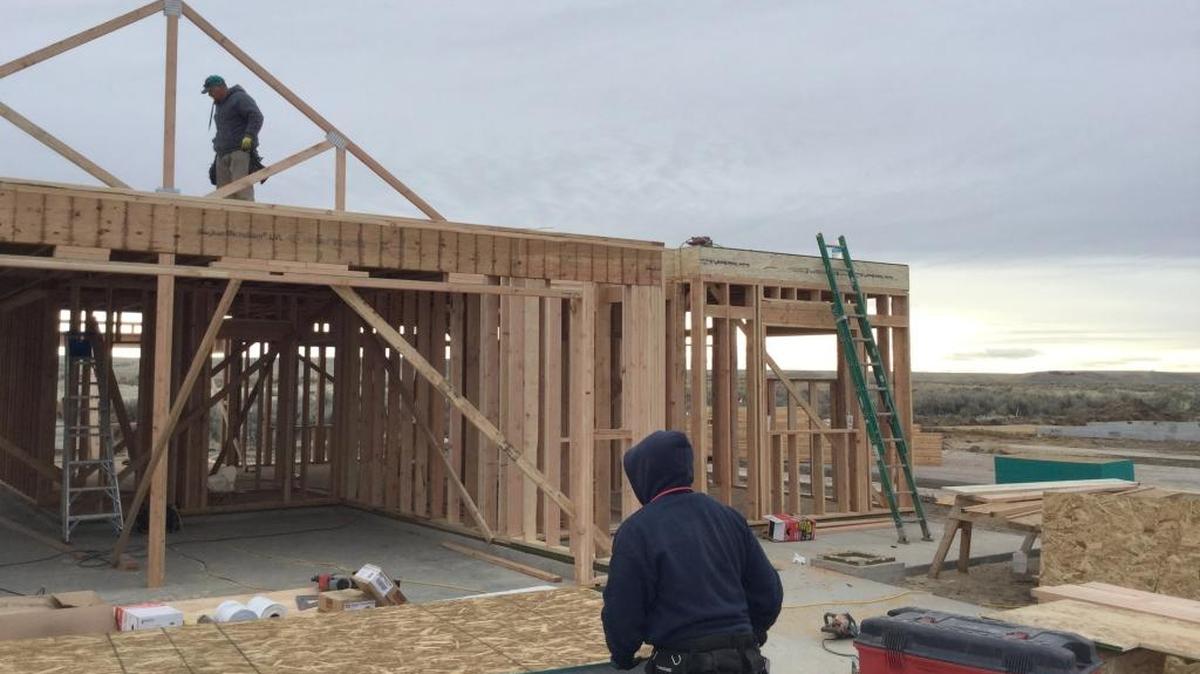 A construction crew works on a house in the Painted Ridge subdivision in Columbia Bench southeast of Boise. A bill sought by builders that has passed the Idaho House would require uniform home-building codes across Idaho.