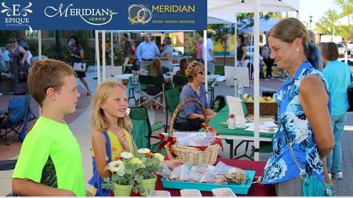 Youth vendors Braxton and Bella Mauk sell wares to shopper Becky Breshears at a event Sept. 10 in Meridian previewing the Youth Farmers Market kicking off soon.
