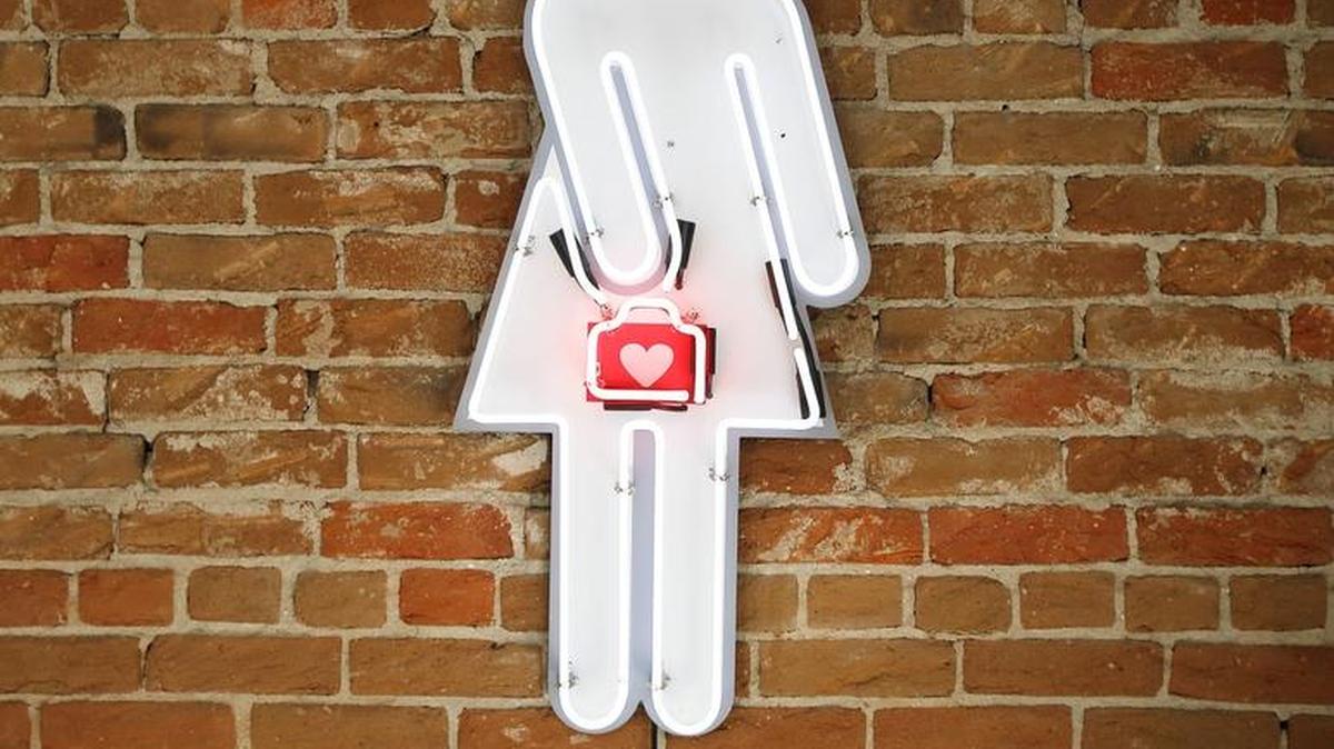 The original “Ms. Box” neon sign that drew attention to the salon’s first Downtown location is now a permanent fixture in Lane’s office.