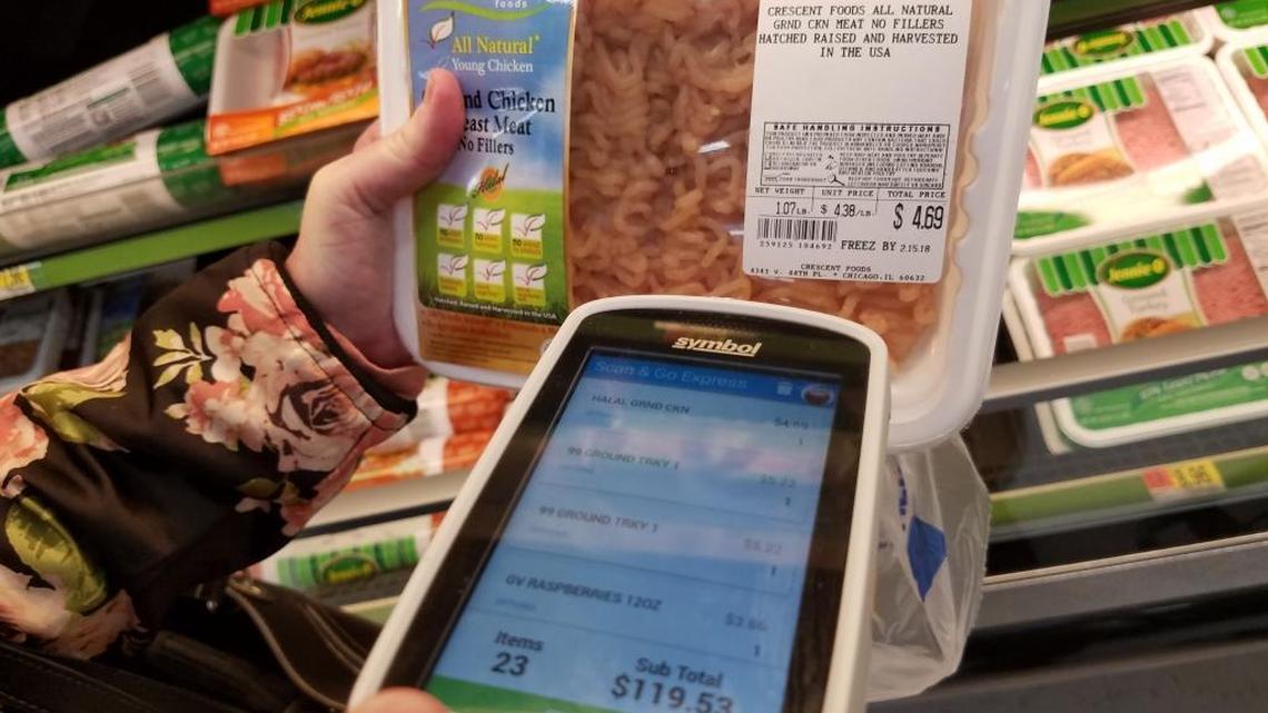 Kim Mathewson uses a handheld scanner to buy a package of ground chicken at the Walmart in Meridian on Thursday. It was her first time using the system. “It’s a lot of fun,” she said.