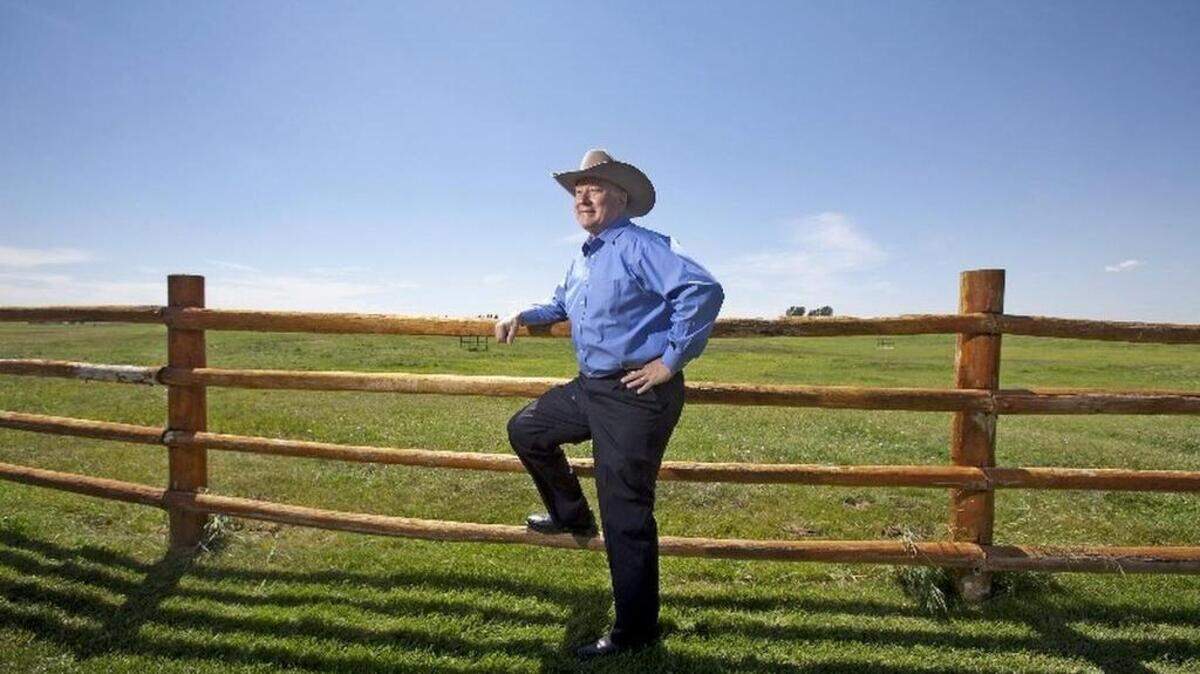 Limping from knee surgery, Frank VanderSloot rushed to his car to retrieve his cowboy hat for this photo. Having the common touch is key to his success, says Debra Lish, who sells Melaleuca and raises horse in Pocatello: "He's just like us."