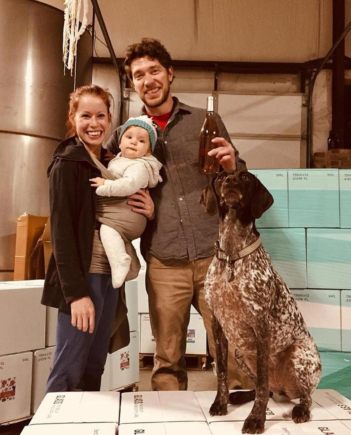 Winemaker Travis Walker with his business partner and wife, Mallory; their 1-year-old daughter, Harper, and the family’s German pointer Roux.