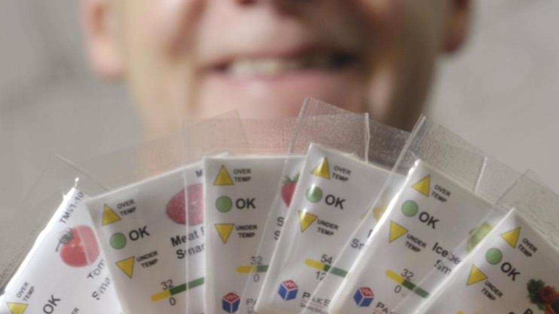 PakSense founder Tom Jensen displays a handful of the company’s Smart Labels in 2008. The labels track temperature during food transport and storage.