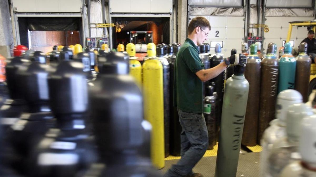 Norco employee Ben Day sorts empty gas containers to be refilled on the floor of Norco’s Boise facility in this Statesman photo from a few years ago.