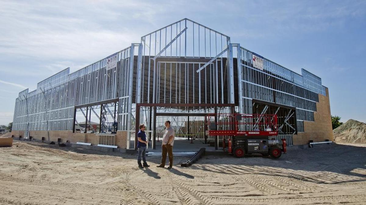 Keith Jones, owner of Datum Construction, left, and Jason White, vice president or White-Leasure Development Co., talk about the Rite Aide that was under construction near the intersection of Victory and Eagle near Meridian in May.