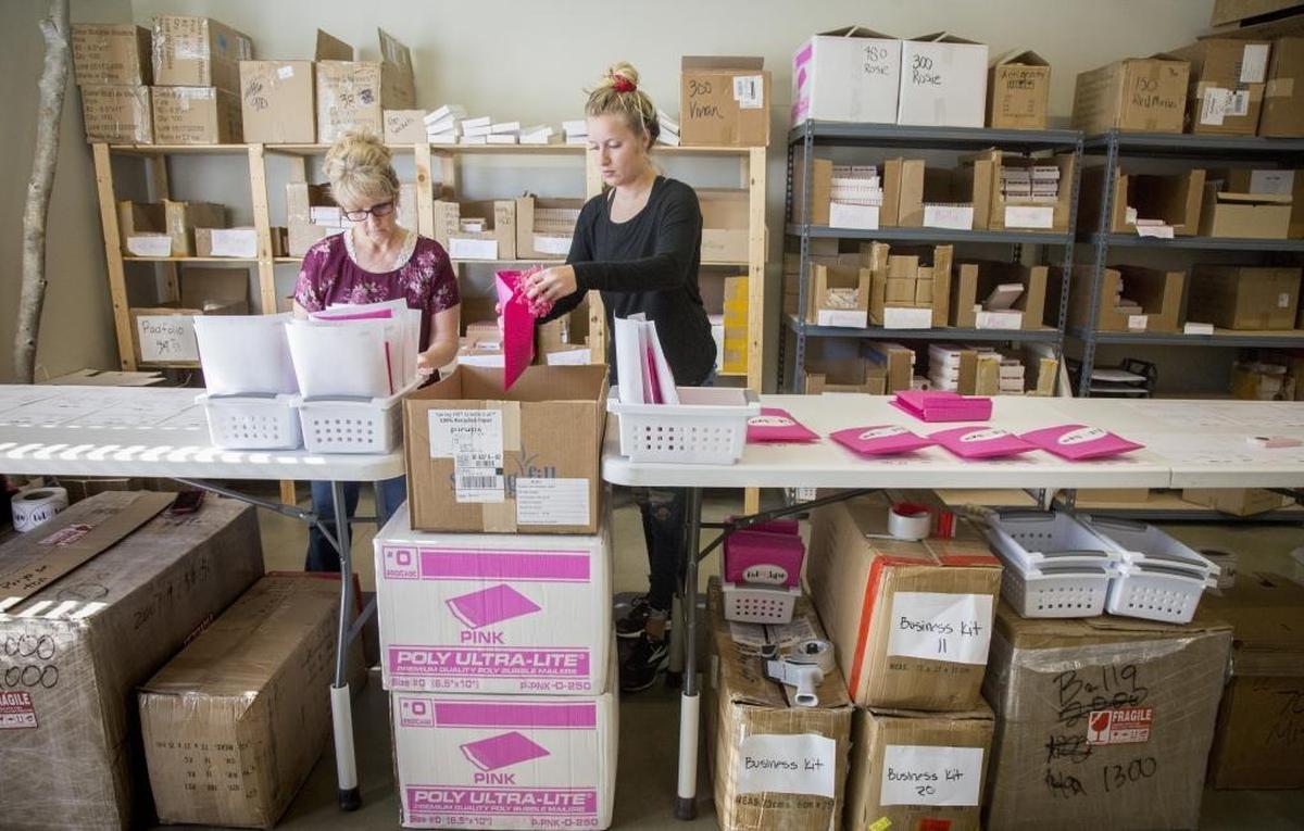 Joy Bowman, left, operations lead, and Jazmin Braden work the packaging assembly line in Red Aspen’s tiny office/warehouse/studio in Boise’s East End. The company’s record so far is 517 orders in a day.