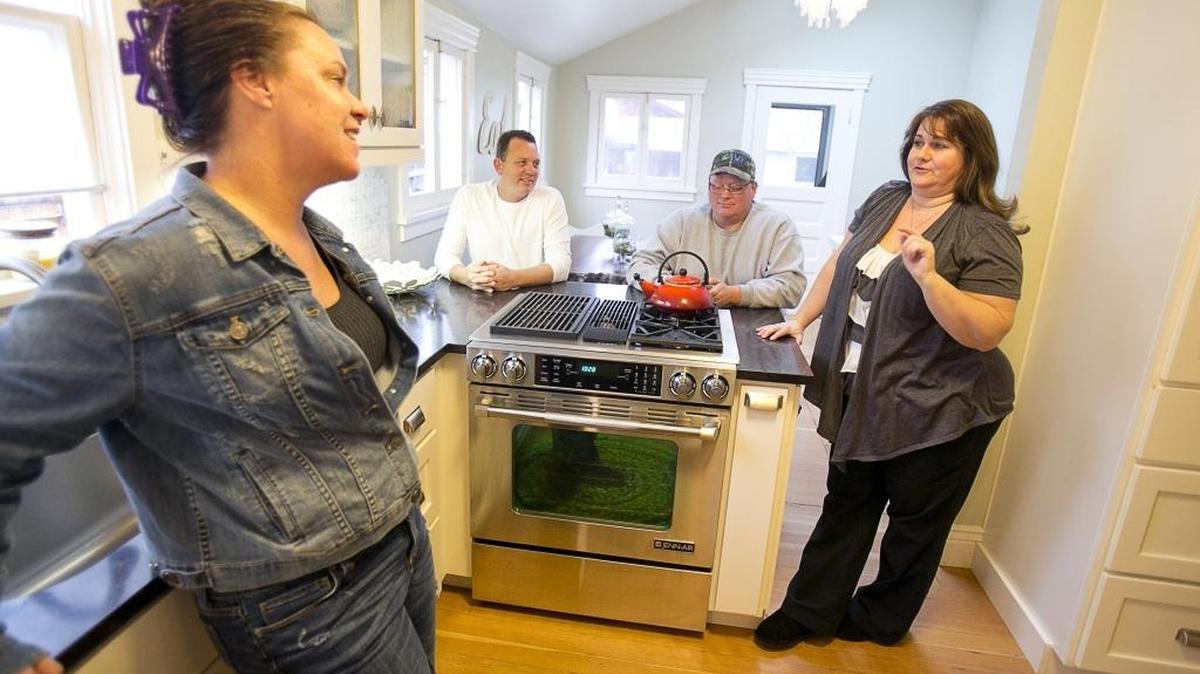 From left, Julie Hergenrother, Ty Hergenrother, Robert Hergenrother and Christine Hergenrother talk in the kitchen of a North End house they rented using Airbnb as an alternative to staying in a hotel in January 2015.