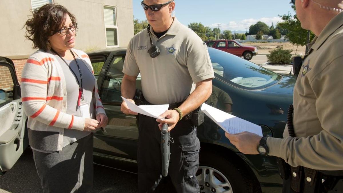 Mobile Crisis Unit clinician Diana Wasser works with Ada County Sheriff Deputies Jared Meyer, center, and Tyler Stenger in a new pro-active program for people with mental health issues. The program provides officers with additional information when they’re walking into a crisis situation.