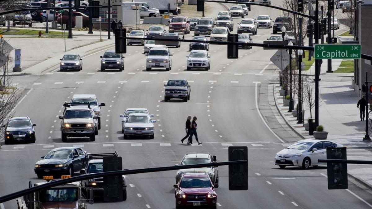 Pedestrians cross five lanes of traffic on Front Street in Downtown in March.