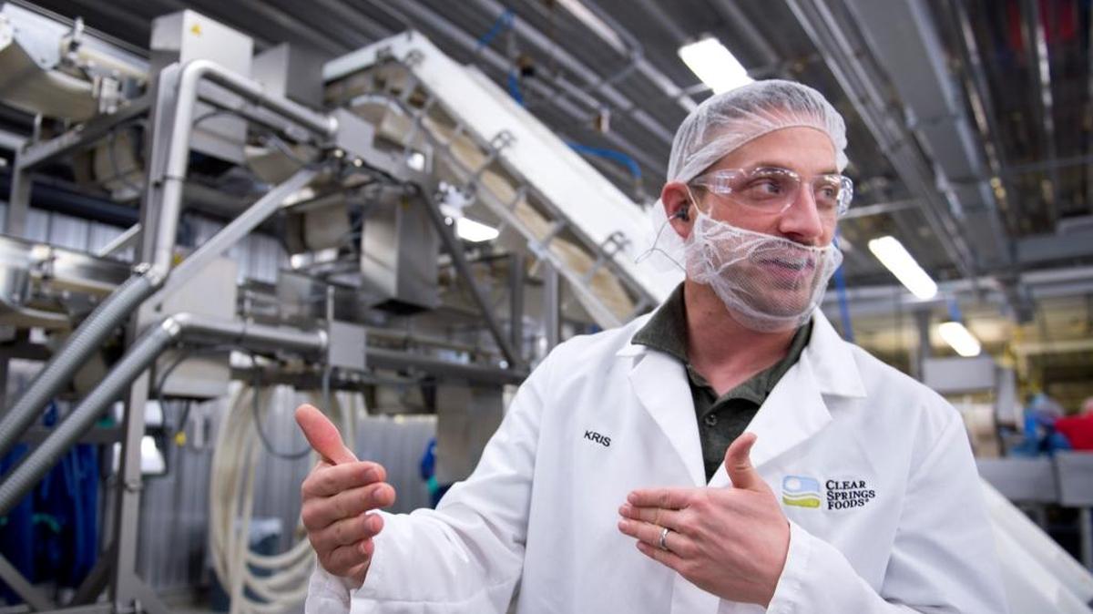 Kris Henna, director of operations, explains the software that makes automation process work at the Clear Springs Food Inc. processing facility near Buhl.