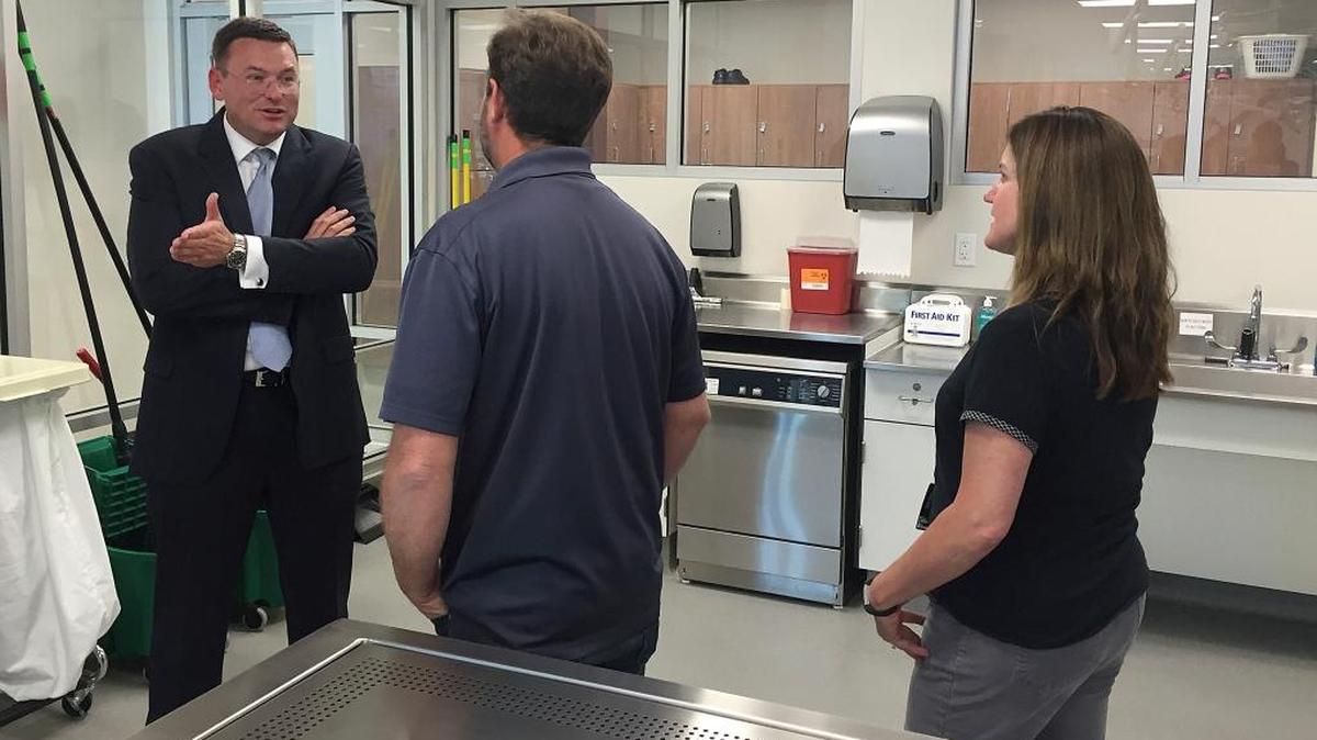 Robert Hasty, dean of the for-profit Idaho College of Osteopathic Medicine, talks with Idaho State University Meridian Health Science Center employees Chris Wilson and Nancy Carpenter in this June 2016 photo. ICOM and ISU reached an agreement that will allow ICOM students to use the public university’s facilities. (AP Photo/Rebecca Boone)