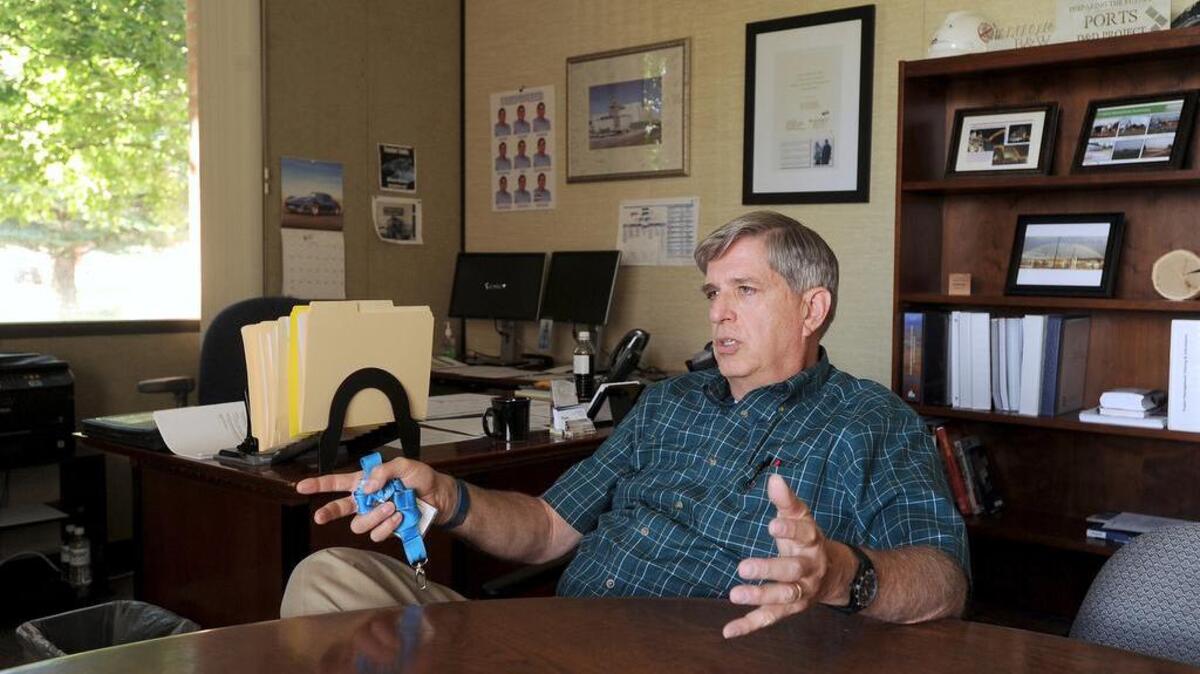 Fred Hughes, president and program manager of Fluor Idaho, in his office in Idaho Falls. Hughes is back working at the U.S. Department of Energy's desert site for a fourth time.